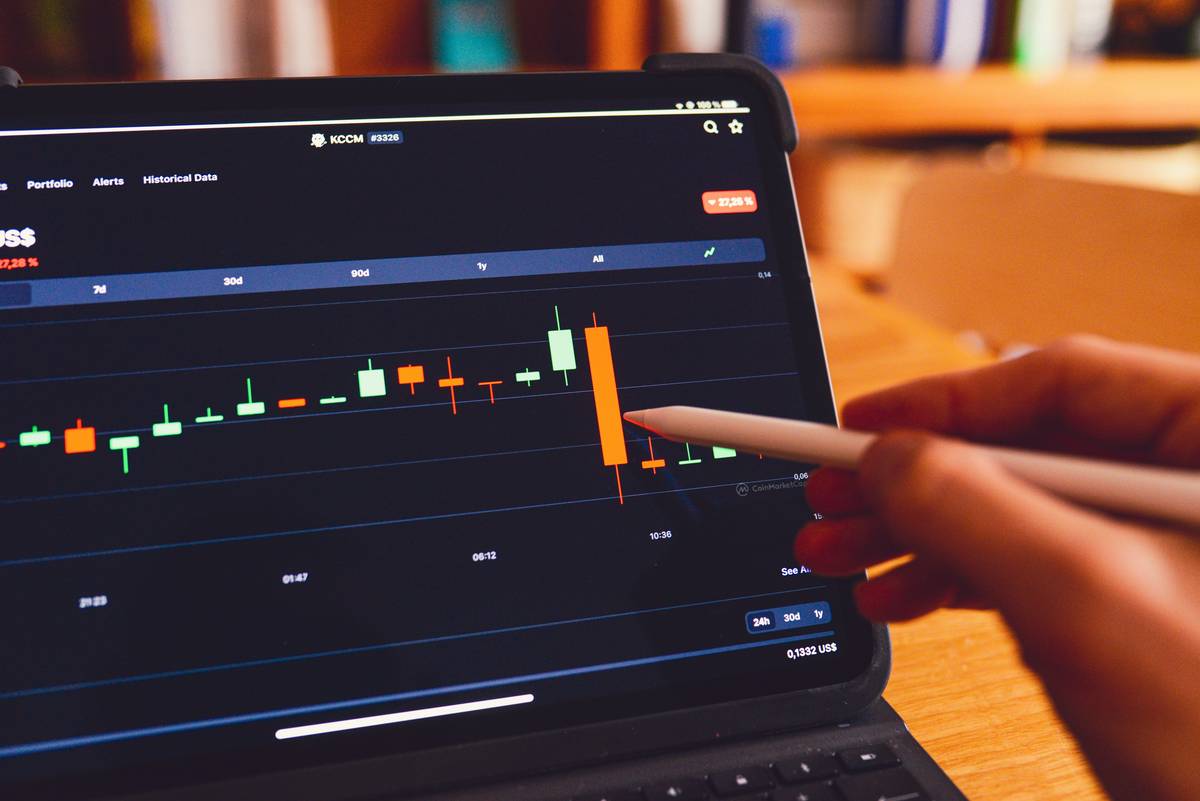 Screenshot of virtual stock trading software showing portfolio dashboard with stock symbols, prices, and performance charts