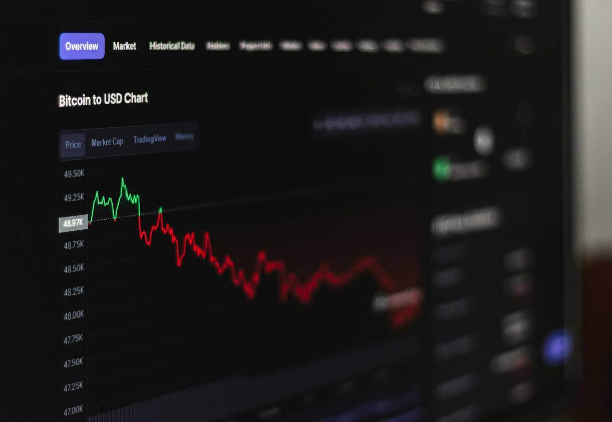 Mobile screenshot of a risk-free trading practice app showing simulated stock trades and portfolio balance
